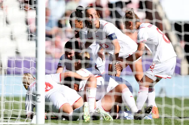 Rahel Kiwic of Switzerland celebrates with teammates after scoring their team's second goal