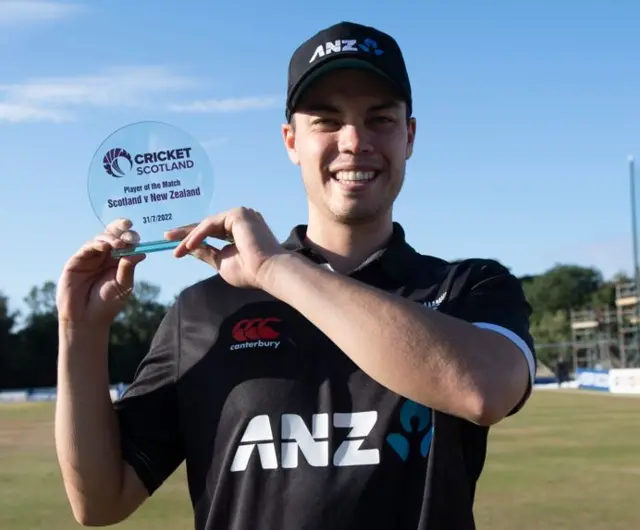 Mark Chapman shows off his award