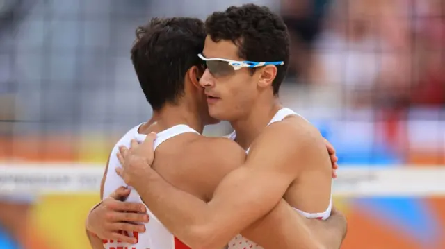 Javier and Joaquin Bello hugging