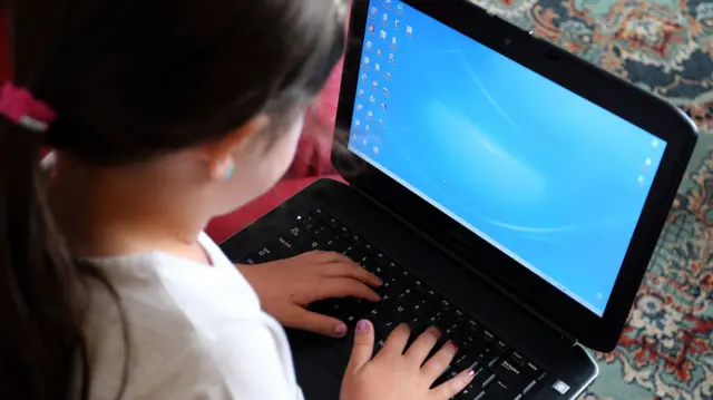 image of a young girl using computer