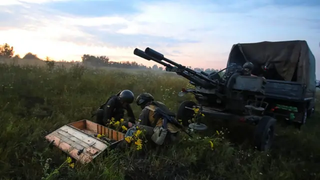 Ukrainian servicemen next to a ZU-23-2 anti-aircraft cannon near a front line in Kharkiv region