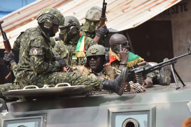 Members of Guinea's armed forces celebrate after the arrest of Guinea's president, Alpha Conde, in a coup d'etat in Conakry on September 5, 2021.