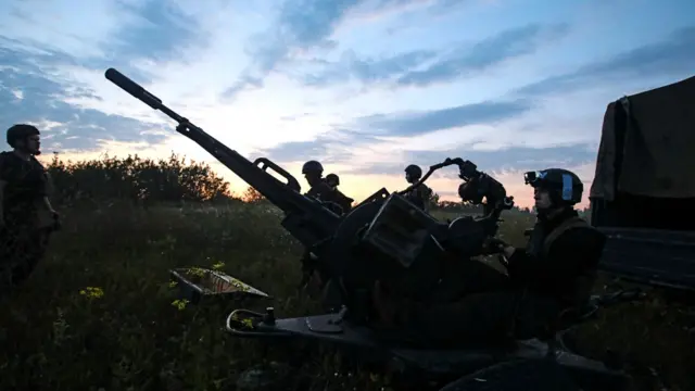 Ukrainian servicemen next to a ZU-23-2 anti-aircraft cannon near a front line in Kharkiv region