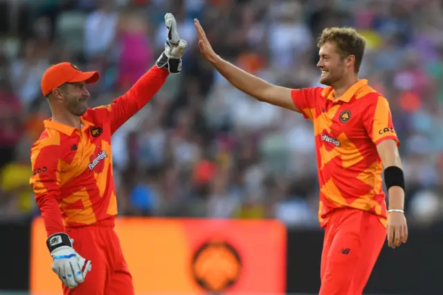 Matthew Wade (left) and Tom Helm (right) high-five after taking a wicket for Birmingham Phoenix