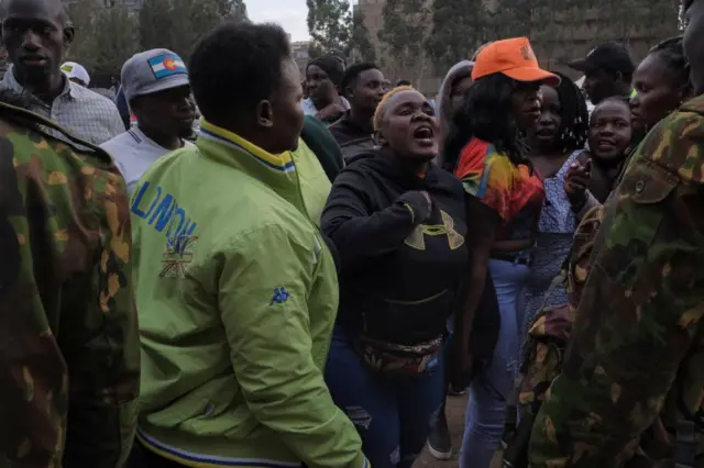 A woman screams at police officers at the St Theresa Girls Secondary School polling station and counting centre, one day after Kenya's general elections in Nairobi on August 10, 2022.