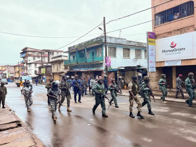 Riot police members patrol the street during anti-government protests in Freetown, Sierra Leone