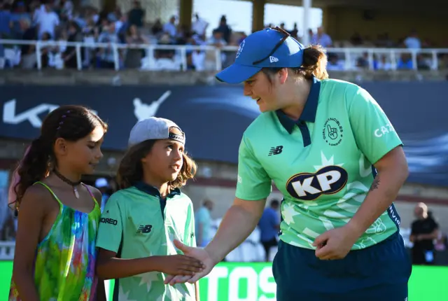 Dane van Niekerk shaking hands with the mascots before the toss