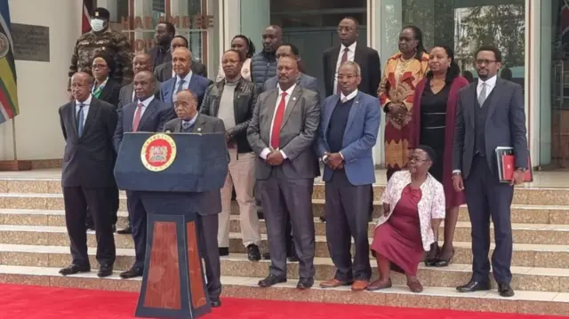 A group of people behind a lectern