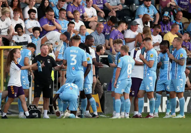 Coventry City manager Mark Robins speaks to players during a water-break during the Carabao Cup match against Bristol City