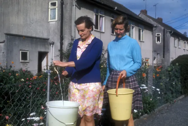 Women use a standpipe during the drought of 1976