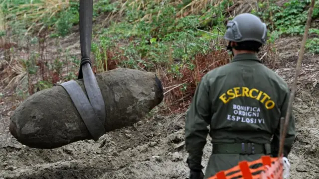 Members of the Italian army remove a World War Two bomb that was discovered in the dried-up River Po which has been suffering from the worst drought in 70 years, in Borgo Virgilio, Italy, August 7, 2022.