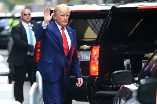 Trump waves to New Yorkers as he heads to his deposition