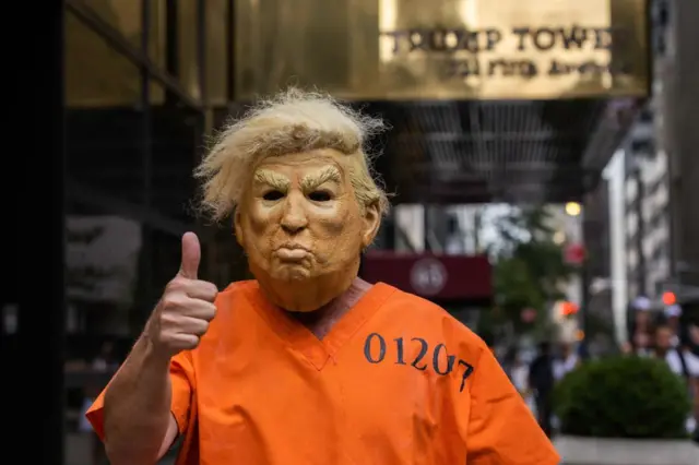 An anti-Trump protester dressed as a prisoner stands outside Trump Tower in New York