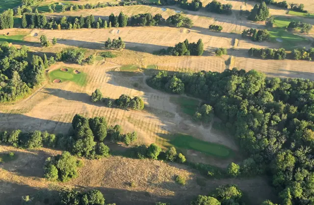 A parched golf course seen from a hot air balloon over Bristol