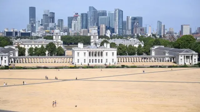 People walk on parched ground in Greenwich Park in London, August 6th 2022