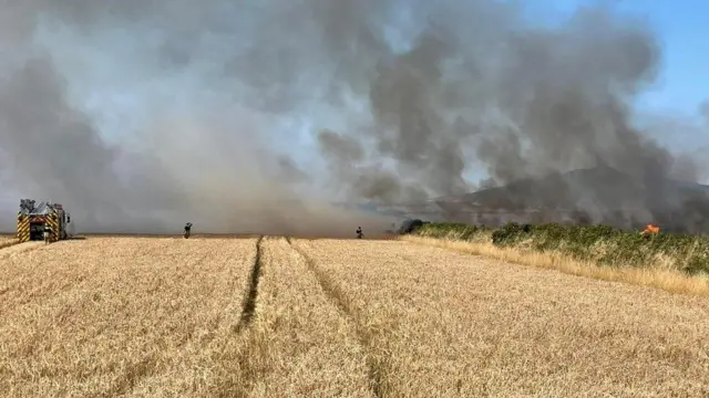 Four crews from across Pembrokeshire are tackling the large blaze which is affecting five corn fields