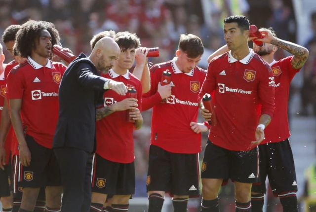 Manchester United manager Erik ten Hag speaks with Manchester United's Alejandro Garnacho and Cristiano Ronaldo during a drinks break