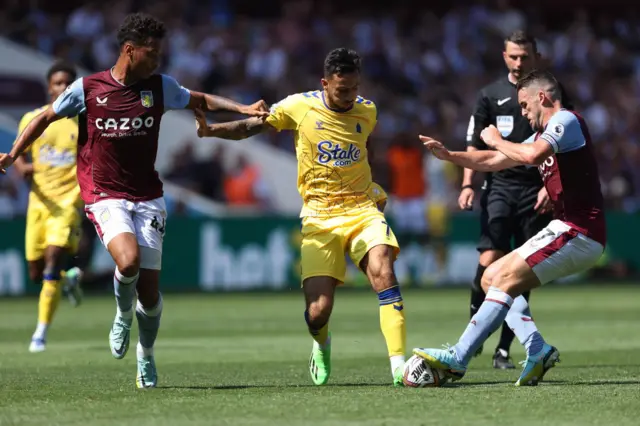 Boubacar Kamara of Aston Villa, Dwight McNeil of Everton and John McGinn of Aston Villa