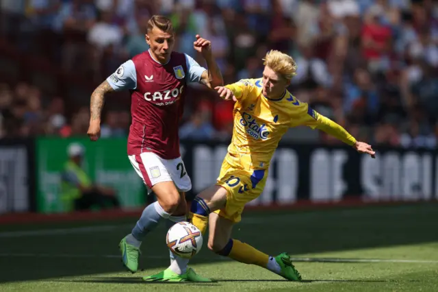 Lucas Digne of Aston Villa and Anthony Gordon of Everton