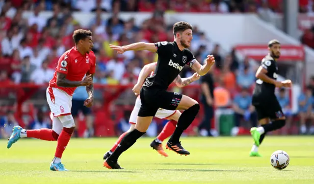 Declan Rice of West Ham United runs with the ball whilst under pressure from Jesse Lingard of Nottingham Forest