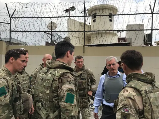 Laurie Bristow speaks with military staff as they oversee the UK evacuation effort in Kabul