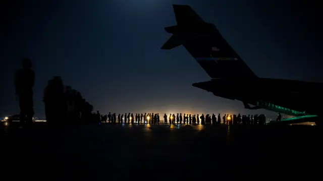 A US Air Force crew prepare for qualified evacuees to leave Afghanistan