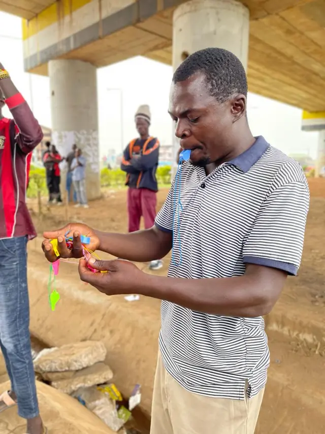 A man holds whistles