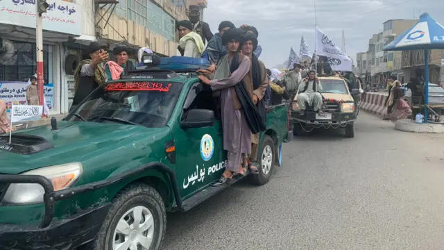 Taliban fighters on trucks in Kandahar