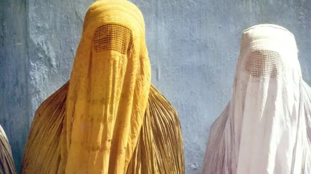 Two women wearing full burkas