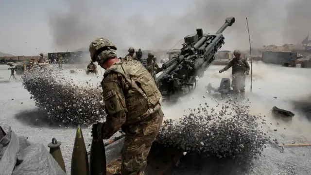 US Army soldiers fire an artillery piece