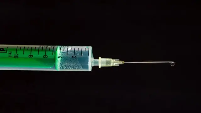 A syringe containing a vaccine dose.