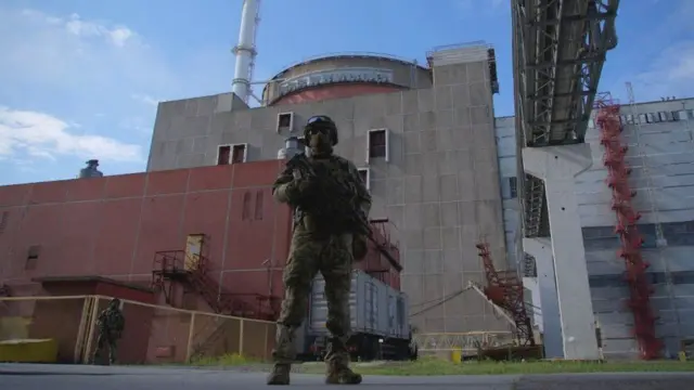 A Russian soldier standing outside the Zaporizhzhia nuclear power plant