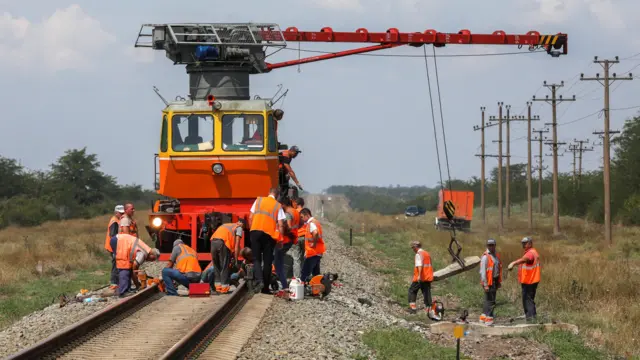 Workers repair a railway near Azovskoye settlement in the Dzhankoy district, Crimea