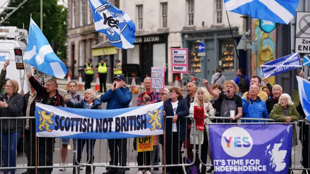 Pro-independence protesters gather outside the venue in Perth