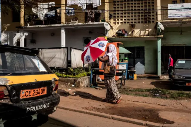 A woman carries an umbrella in Yaounde, Cameroon.