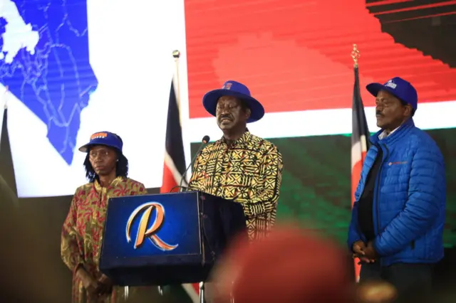 Azimio la Umoja One Kenya coalition presidential candidate Raila Odinga (C) alongside his running mate Martha Karua (L) and former Kenya's vice president Kalonzo Muysoka (R) speaks during a press conference at KICC buildings.