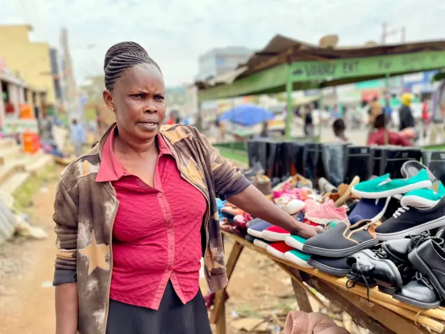 Woman standing by some shoes