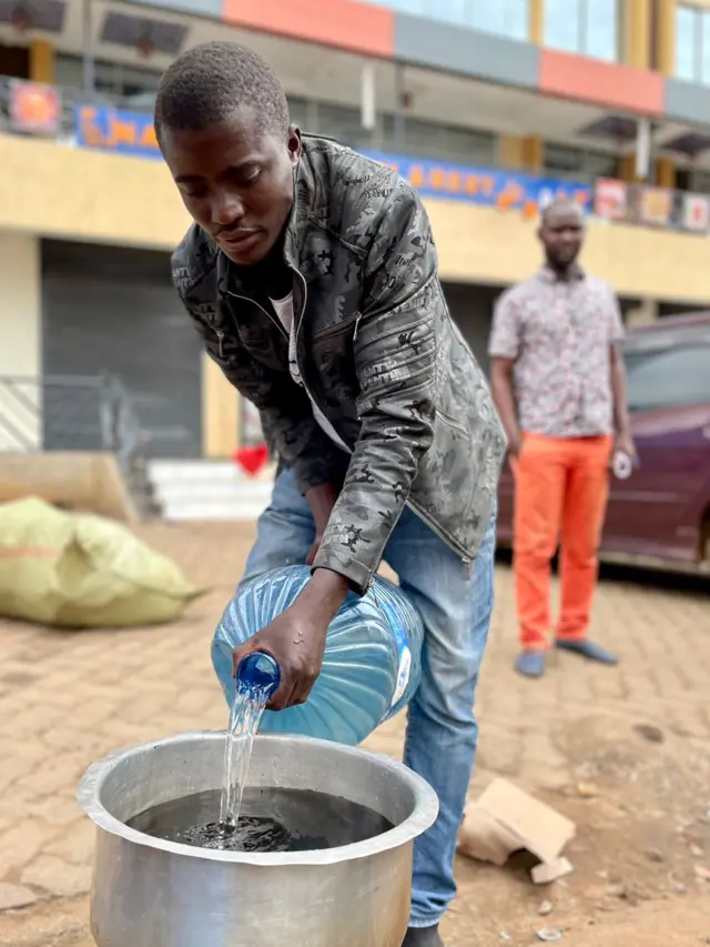 Man pouring a bottle of water