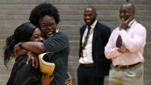 Genevieve Boateng and her teacher Sharna-Kay Prehay hug at Harris City Academy in Crystal Palace, London