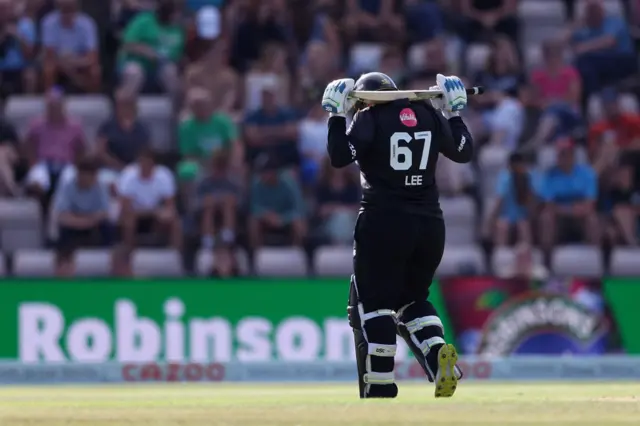 Lizelle Lee walks off the pitch after getting out with her bat over her shoulders