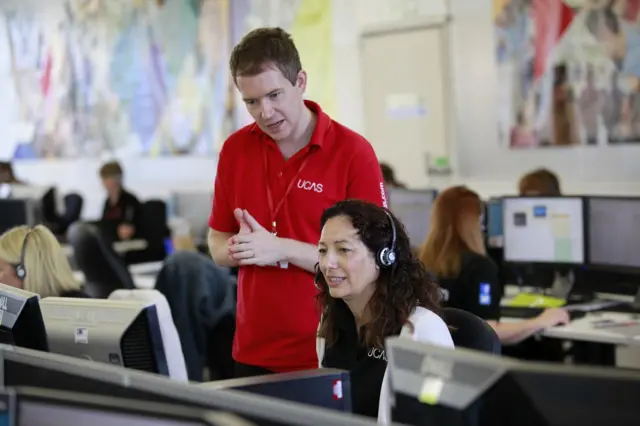 A Ucas official looks over a computer