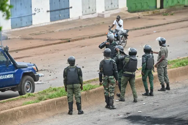 Guinea anti riot policemen fire teargas as protesters block roads and hurl rocks in Conakry on July 28, 2022,