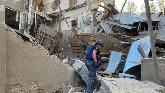 A member of the State Emergency Service works at a site of a building of the Kharkiv National Technical University heavily damaged by a Russian missile strike