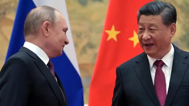 Russia's President Putin talks to China's President Xi