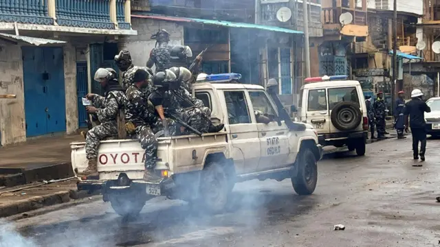 Riot police patrol Freetown