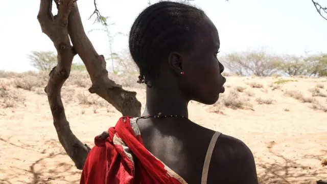 A woman looking out at arid land