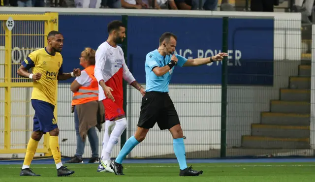 After a lengthy VAR check, the hosts are awarded a penalty for a harsh handball on Connor Goldson