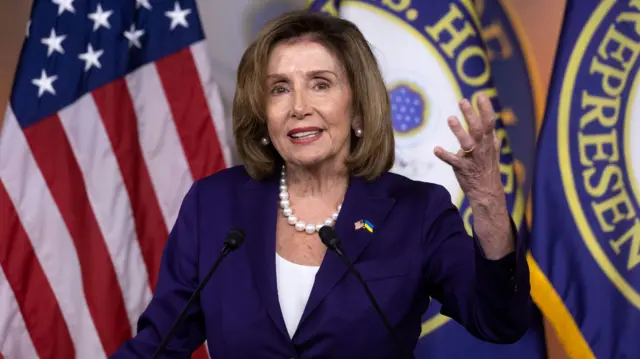 US Speaker Nancy Pelosi stands in front of a US and House of Representatives flag, as she holds a news conference on Capitol Hill