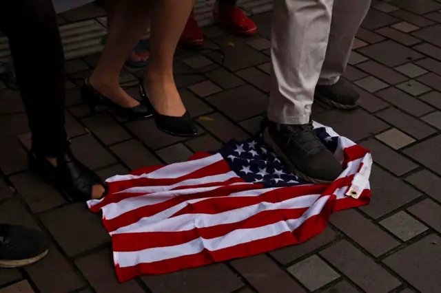 Demonstrators step on a U.S. flag during a protest against U.S. House of Representatives Speaker Nancy Pelosi's visit, in Taipei.