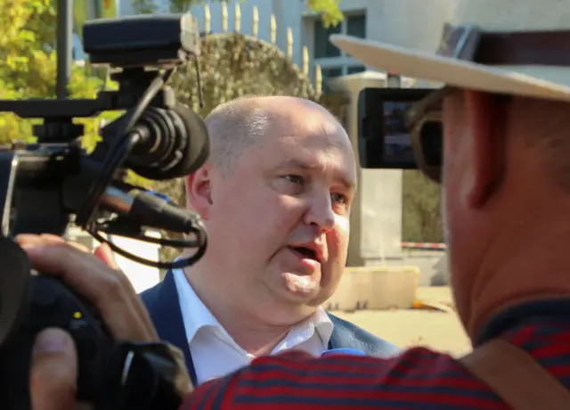 Mikhail Razvozhayev speaking to reporters